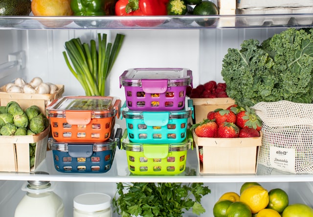 Shows a refrigerator with food, meal planning and meal prepping